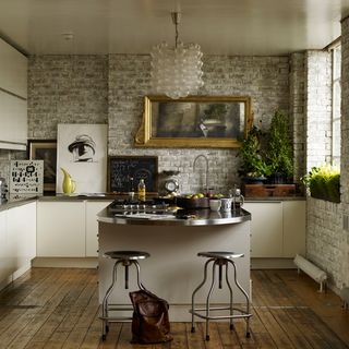 Kitchen with brick walls and wooden flooring