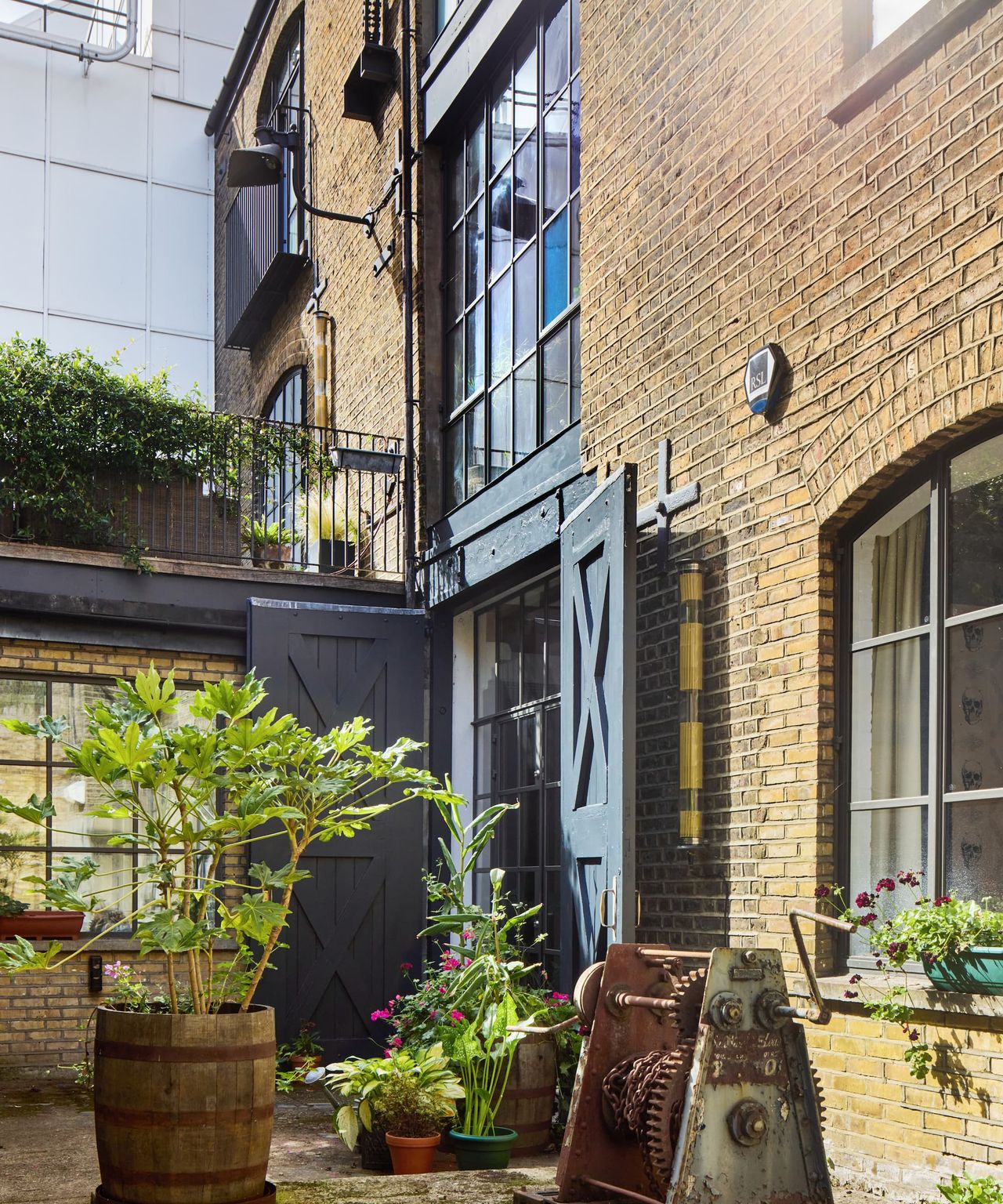 A garden path leading to wooden doors