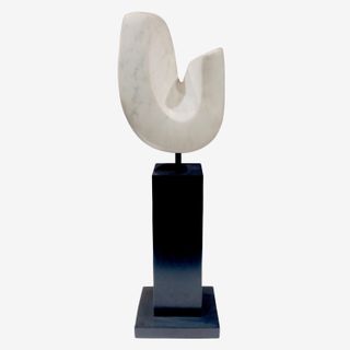 A sculpture made from white vermont marble with a black base, photographed against a white background