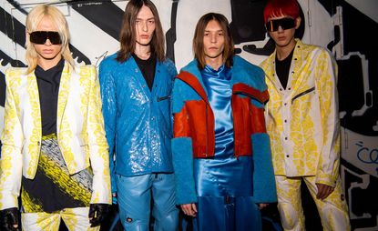 four male models in wearing brightly coloured leather outfits