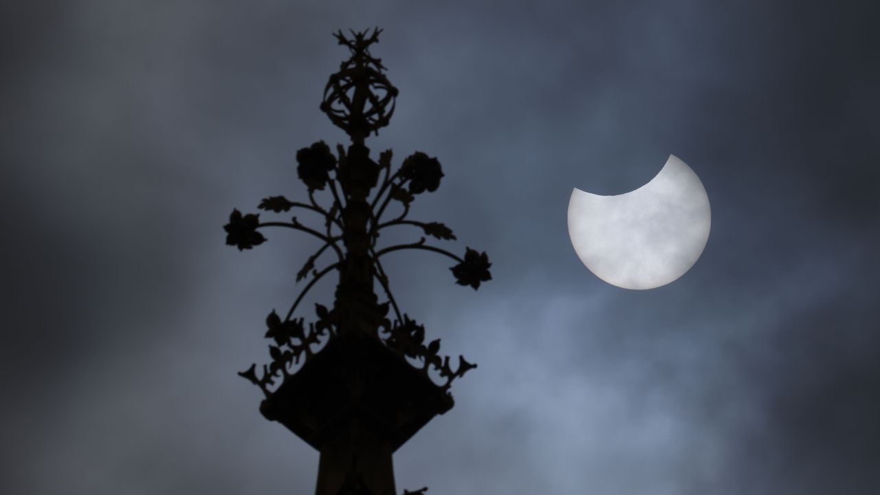 The eclipsed sun seen next to London's Big Ben on June 10, 2021, as photographed by Dan Kitwood.
