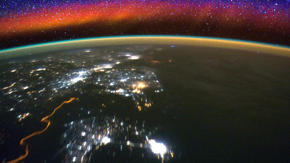 A timelapse view of the ionosphere from the International Space Station, with city lights shining below.