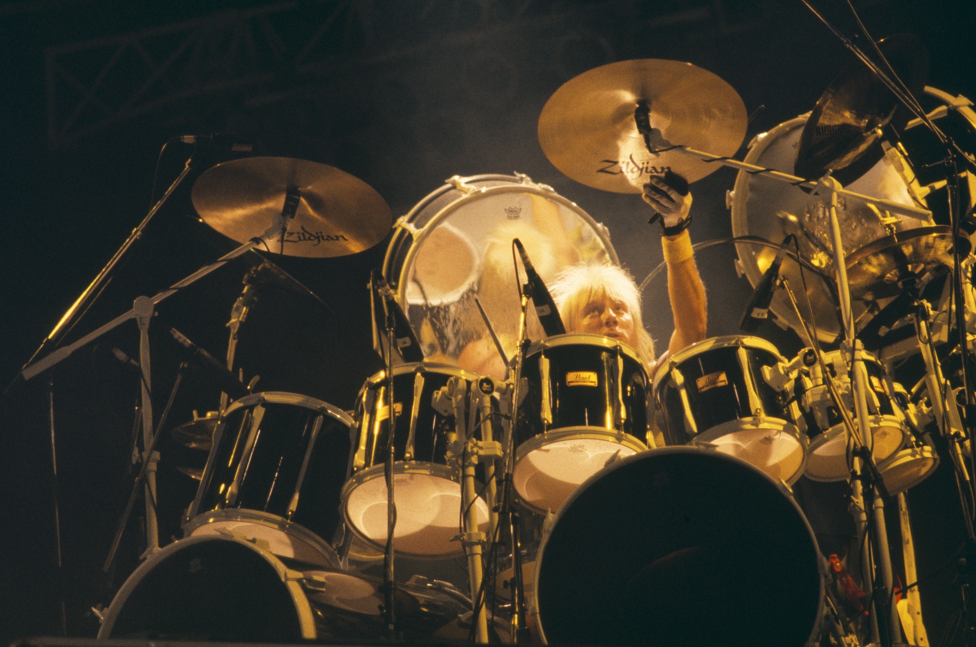Gregg Bissonette, seated behind his drum kit on stage with the David Lee Roth Band on the Skyscraper tour