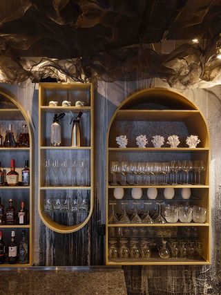 Bar area of the Human restaurant Moscow with gold shelves behind the bar