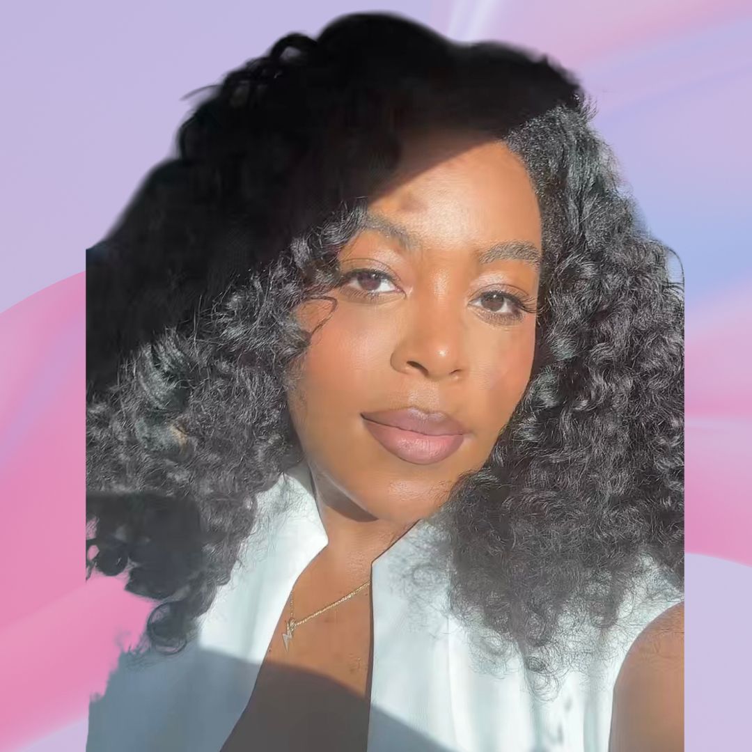 An image of ariel baker surrounded by cyklar perfume oil and bvlgari fragrance magnifier. Set against a purple backdrop white pink fabric swriling behind her head. 