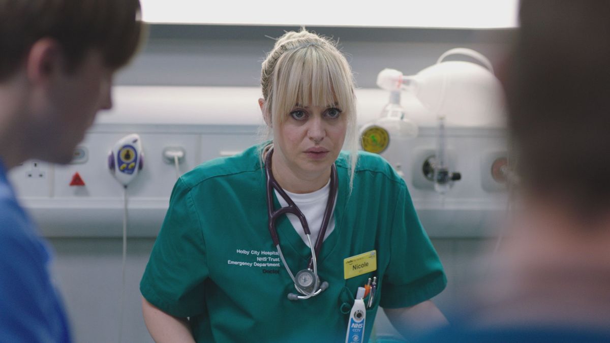 Casualty star Sammy T. Dobson as junior doctor Nicole Piper, treating a patient under Dylan Keogh&#039;s tutelage. 