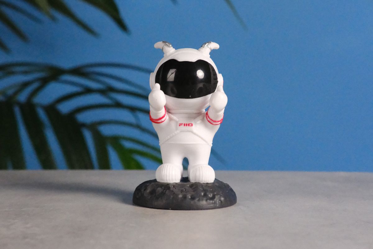 A photo of an astronaut toy against a blue background, taken on the Fujifilm X-E5