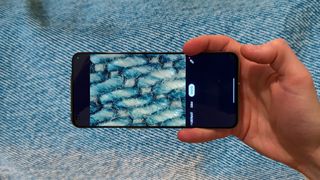 Realme GT 2 Pro microscope camera being used on a pair of jeans