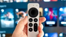 Apple TV 4K Siri remote in front of Apple TV running on a screen