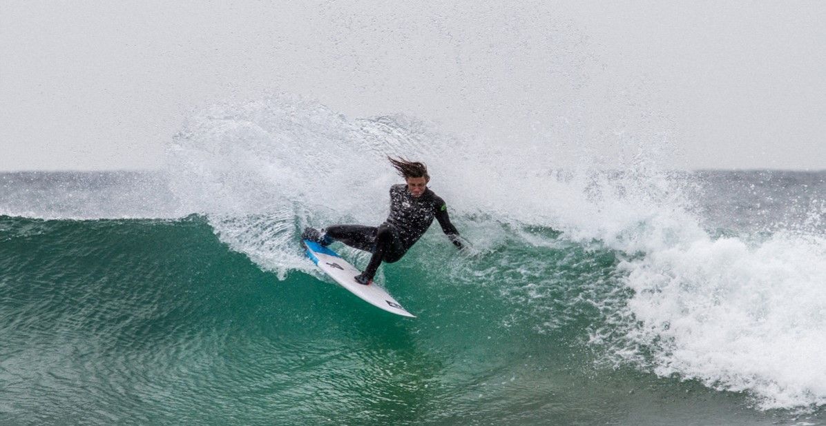 best wetsuit: Pictured here, a surfer riding a huge wave wearing a wetsuit