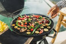 fresh vegetables on grill outdoors at sunset.