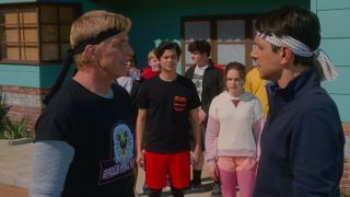 Johnny Lawrence and Daniel Larusso facing each other in front of their students in Cobra Kai