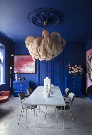 A deep blue toned dining room