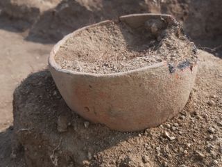 An intact pot found near the man and woman.