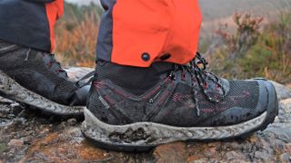 Man's feet wearing Keen NXIS EVO Mid hiking boots