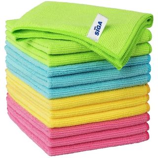 A stack of folded microfiber cloths, pink on the bottom, then yellow, then blue, then green 