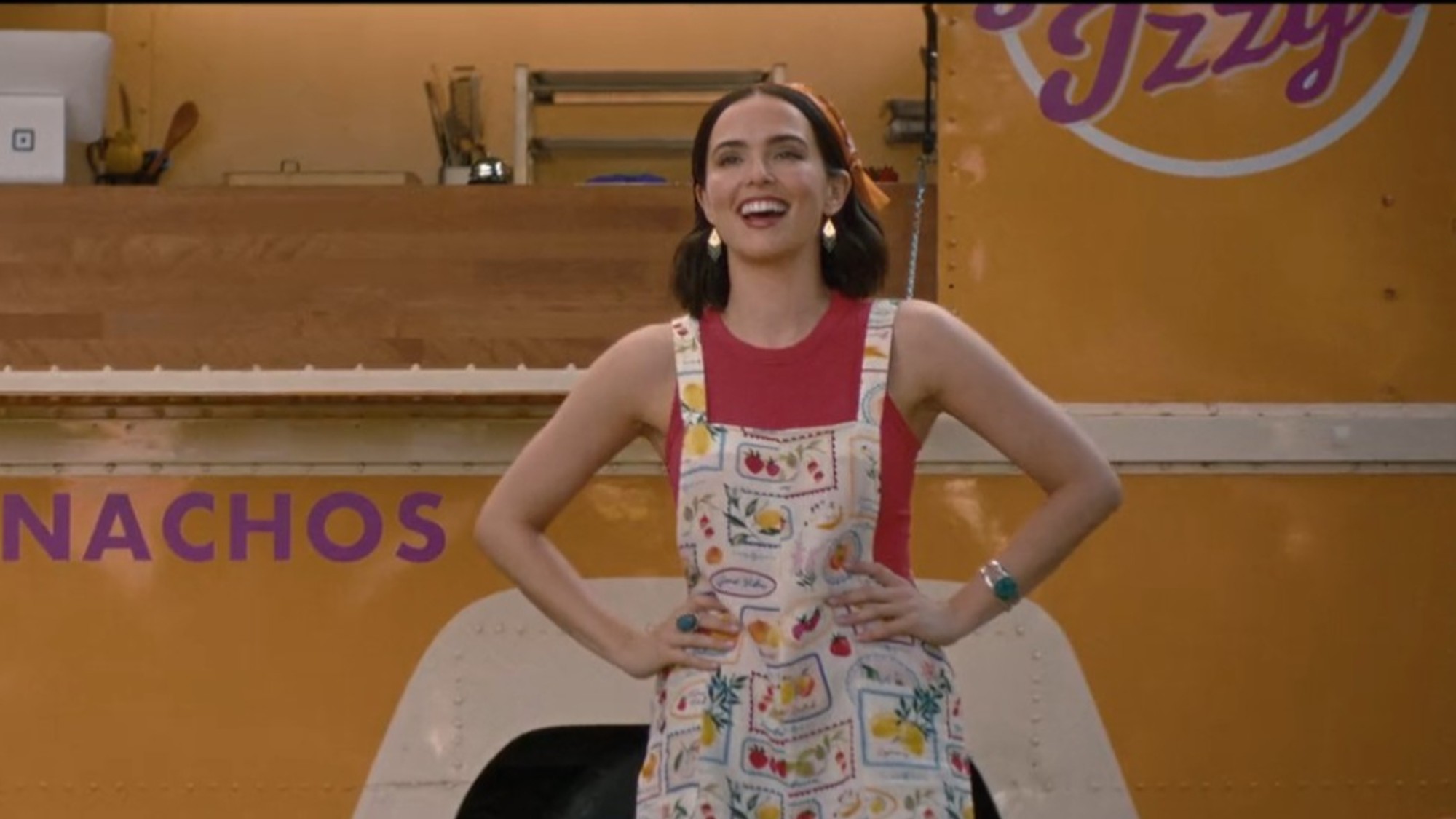 Zoey Deutch smiling in front of a food truck in Voicemails for Isabelle