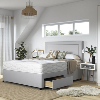 white bedroom with a grey padded headboard