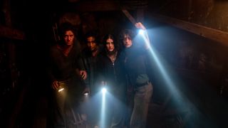 Four Until Dawn characters, shining torches in the dark.