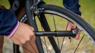 pumping up a racing bike tyre