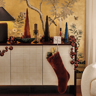 A living room scene featuring various pieces of Christmas decor