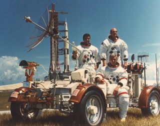 Schmitt, Evans and Cernan are photographed with a Lunar Roving Vehicle (LRV) trainer during the rollout of the Apollo 17 rocket.