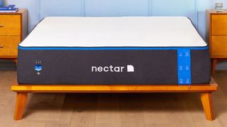 Nectar mattress on a light wooden bed in a colorful room