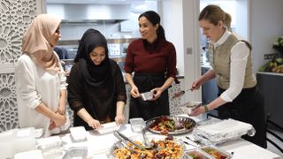 london, england november 21 meghan, duchess of sussex with chef clare smyth r and kitchen co ordinator zaheera sufyaan 2l as she visits the hubb community kitchen to see how funds raised by the together our community cookbook are making a difference at al manaar, north kensington on november 21, 2018 in london, england photo by chris jacksongetty images