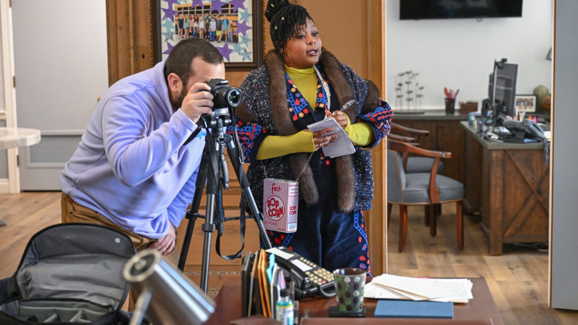 Gbemisola Ikumelo and Eric Rahill working in The Paper Season 2.