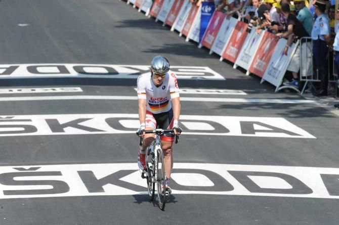 Andre Greipel (Lotto Belisol) crosses the line after being delayed by a crash