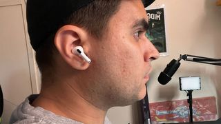An AirPods Pro (2nd generation) bud in the right ear of the reviewer