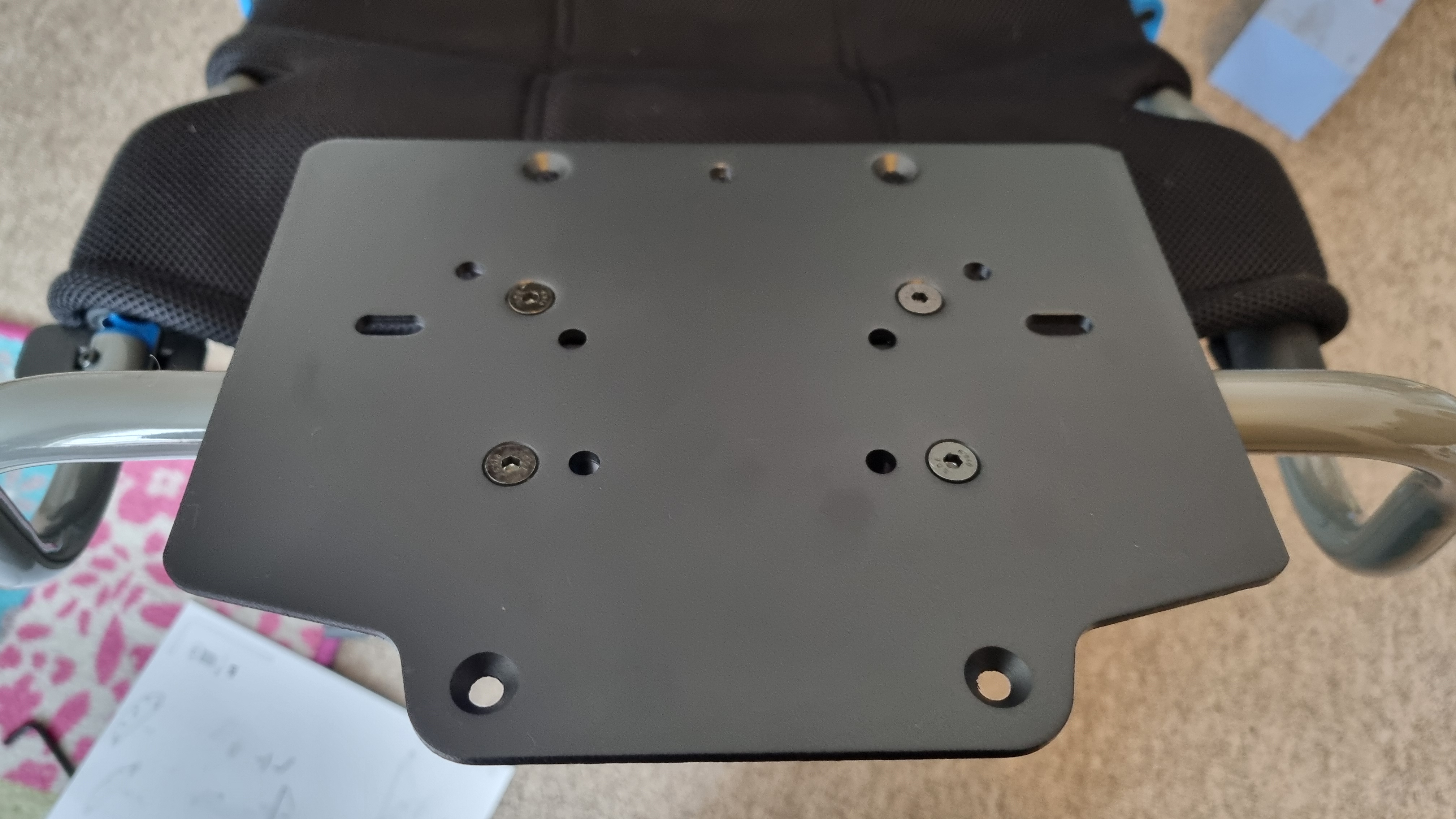 The wheelbase mounting plate, showing the multiple options for wheelbase mounts on the Logitech Playseat Challenge X
