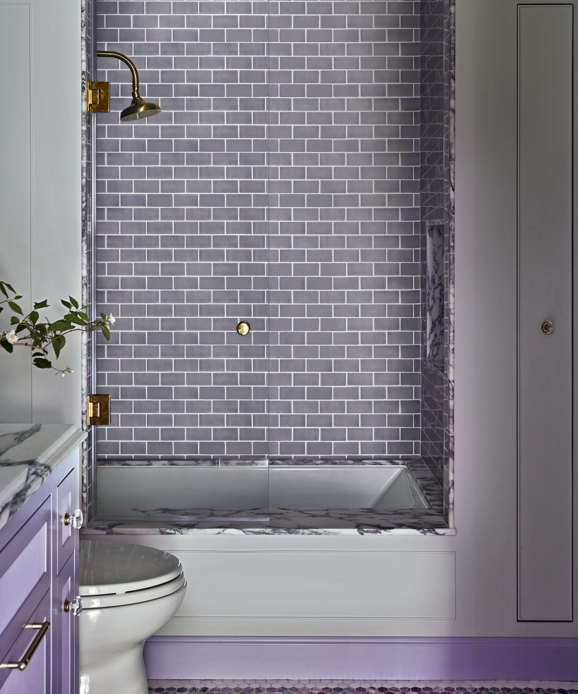 purple tiled bathroom with shower in alcove