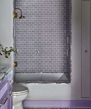 purple tiled bathroom with shower in alcove
