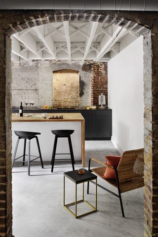 industrial style kitchen with concrete floor by Colleen Healey