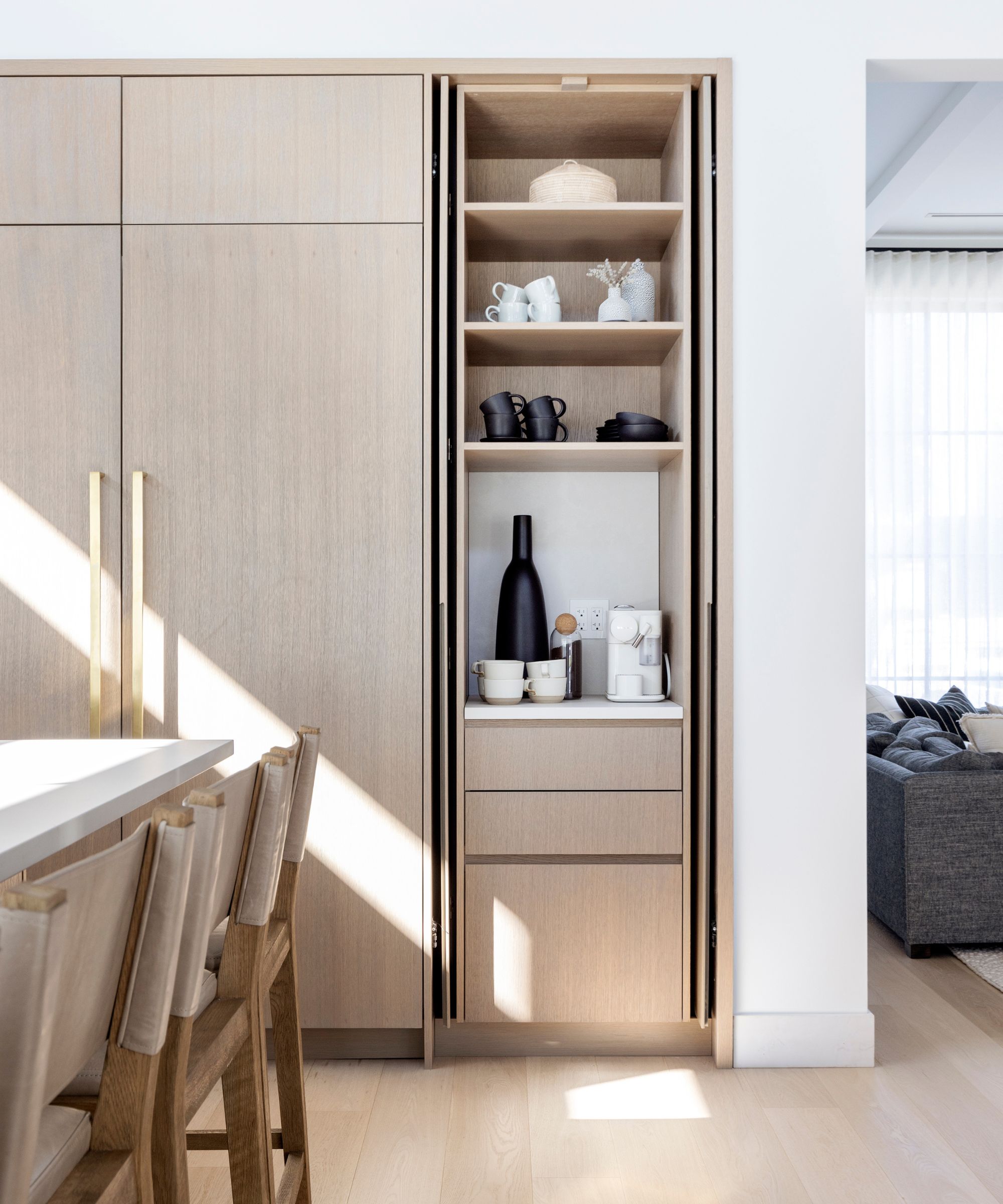 Light wood kitchen cabinets with an integrated appliance garage