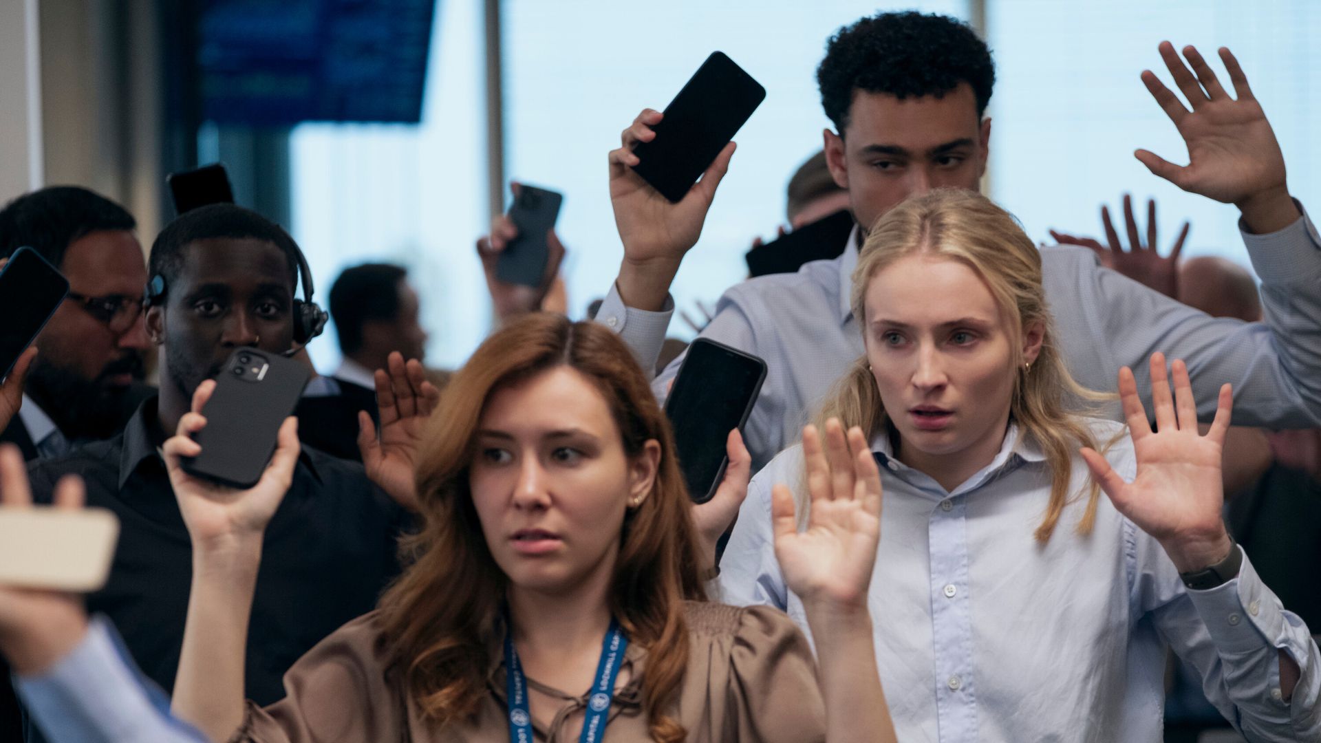 The cast of Steal hold their hands and phones in the air