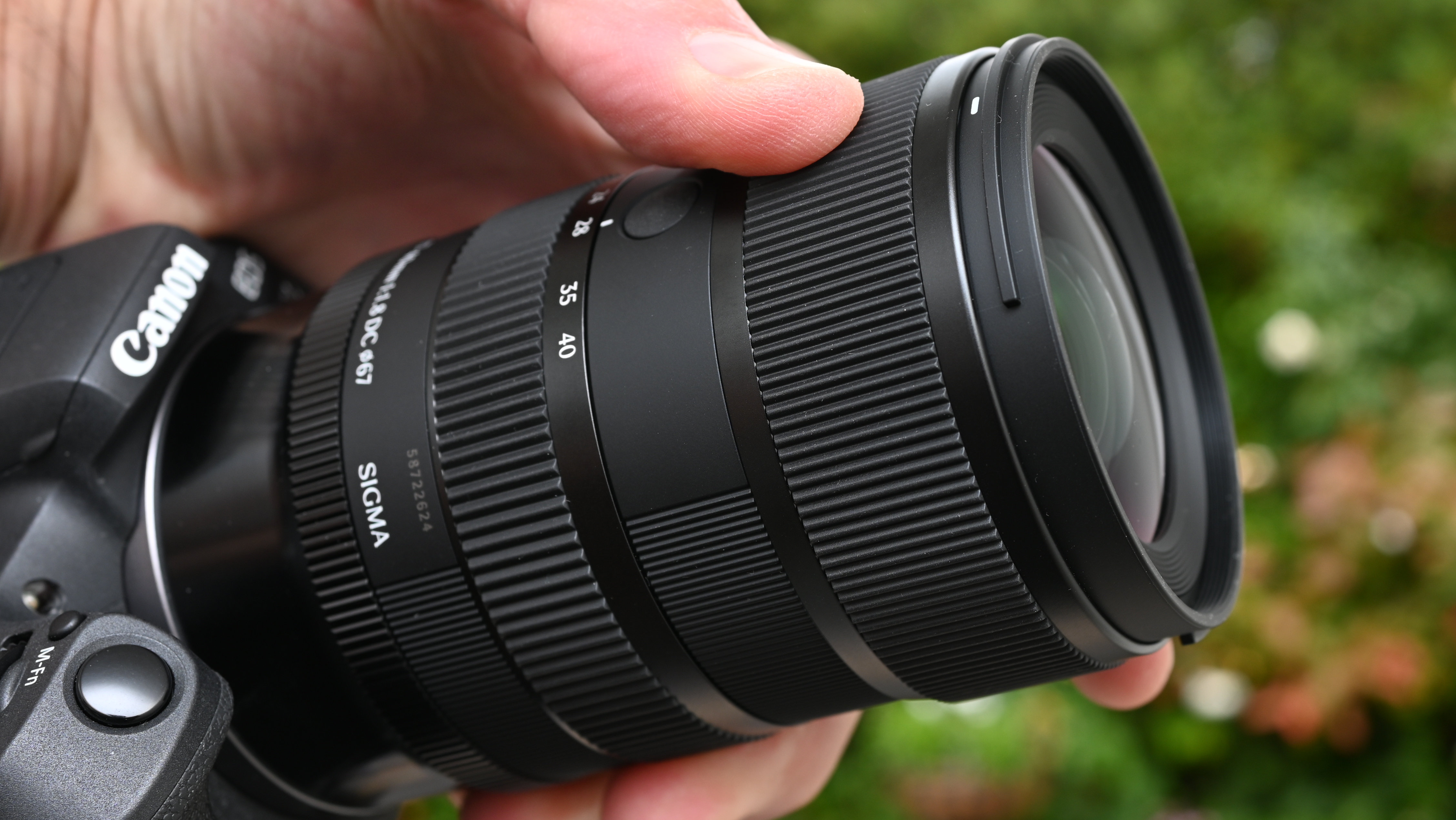 Sigma 17-40mm f/1.8 DC | A product shot held in hand