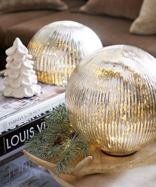 Two gold sphere decorations and a mini Christmas tree decoration