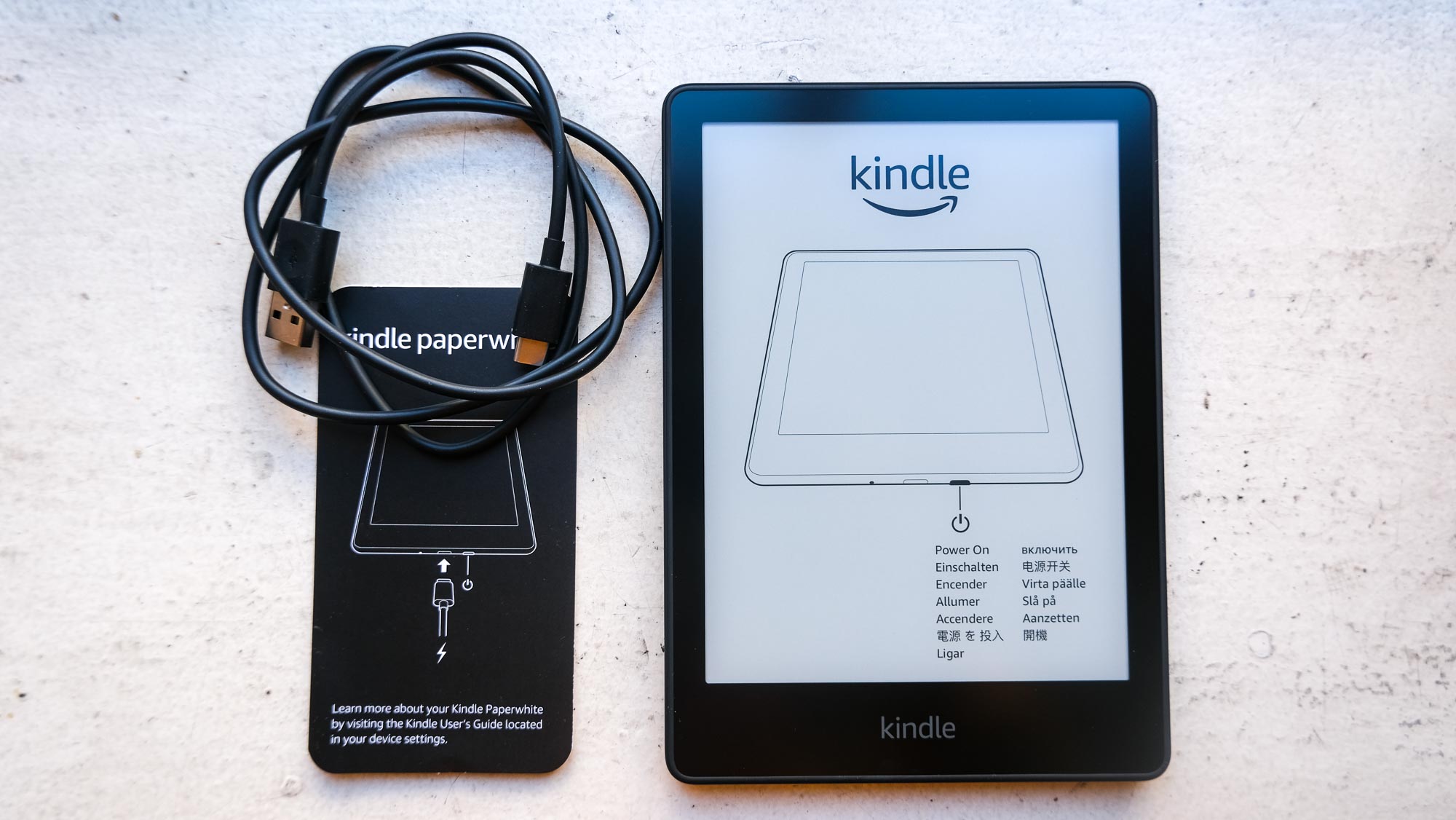 The Kindle Paperwhite 2021 with cord and manual