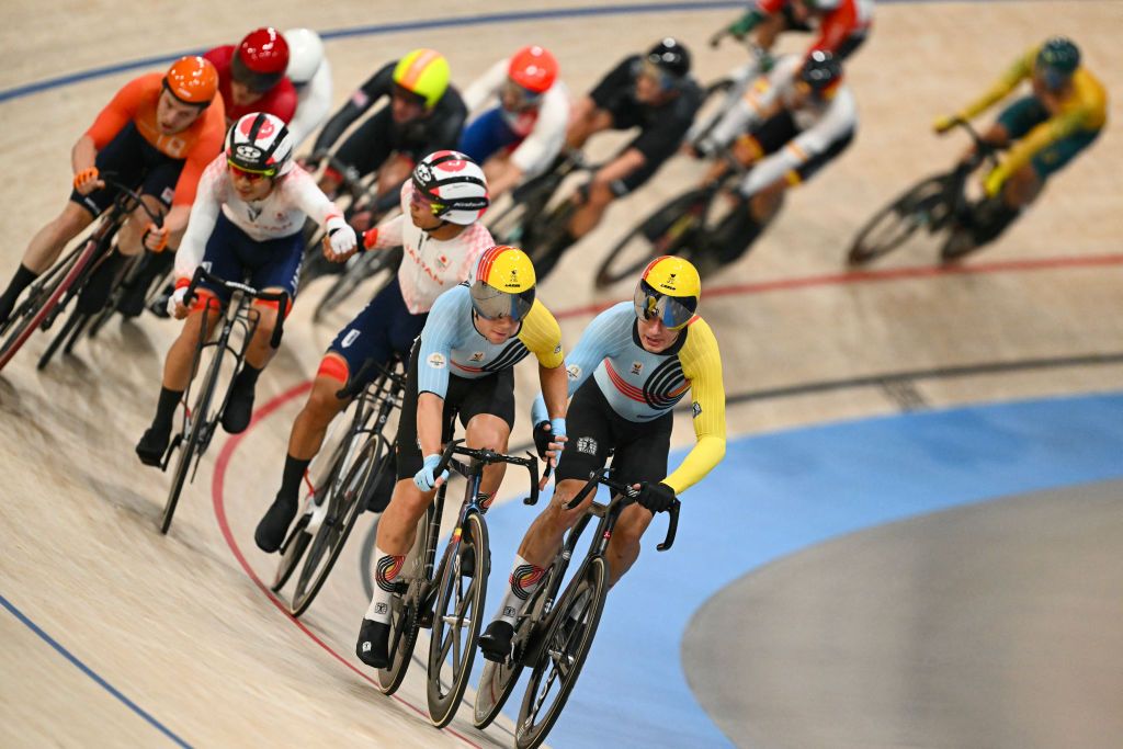 Belgium's Lindsay De Vylder relays Belgium's Fabio Van Den Bossche in the men's track cycling madison final of the Paris 2024 Olympic Games at the Saint-Quentin-en-Yvelines National Velodrome in Montigny-le-Bretonneux, south-west of Paris, on August 10, 2024. (Photo by SEBASTIEN BOZON / AFP)
