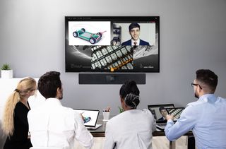 A group sits in front of a display for videoconferencing with the new WolfVision Cynap videobar.