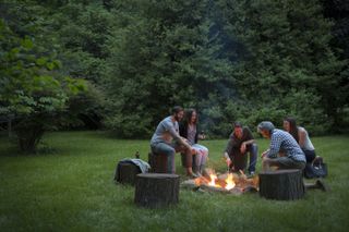 adults sat around a fire pit