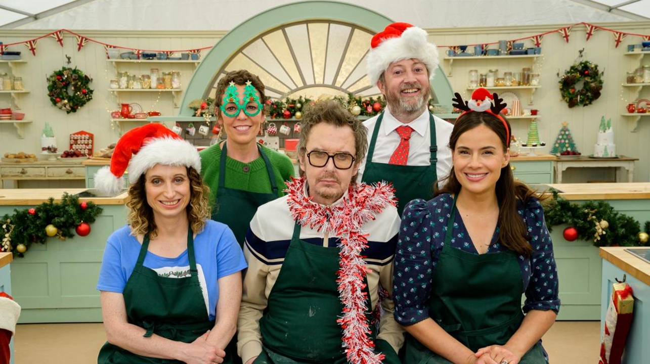 The cast of Peep Show don green aprons and festive headwear inside the cheerfully decorated tent (from left to right: Isy Suttie, Olivia Colman, Matt King, David Mitchell, and Sophie Winkleman).