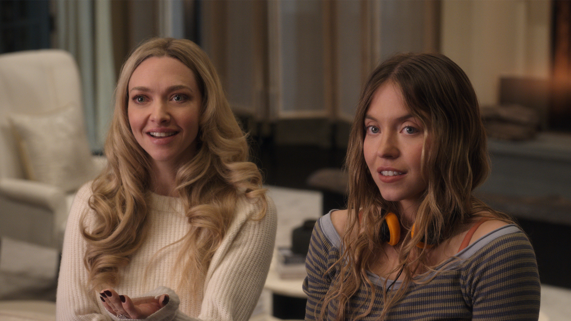 Amanda Seyfried and Sydney Sweeney sitting together in The Housemaid