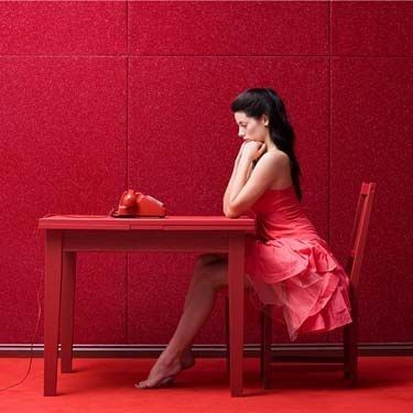 Woman in Red Waiting By Phone