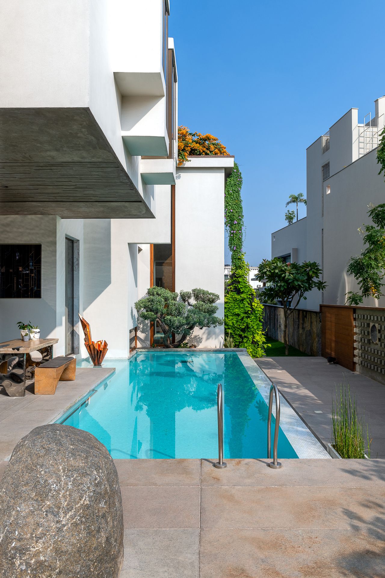 Small modern backyard with narrow swimming pool