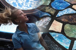 Former NASA astronaut Karen Nyberg's Earth Views fabric squares incorporated into a quilt, titled "Cupola Views," designed with NASA engineer Sarah Ruiz.