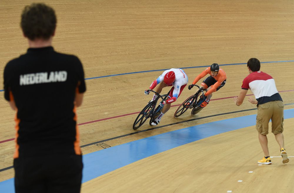 Russia's Denis Dmitriev (C/L) and Netherlands Harrie Lavreysen (C/R) compete in the men's sprint final at the Hong Kong Velodrome during the Track Cycling World Championships