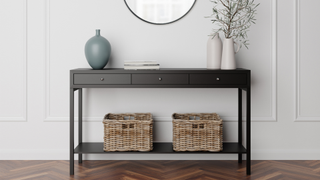 black slimline console table with baskets and wall mirror